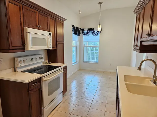 a kitchen with a stove cabinets and a refrigerator