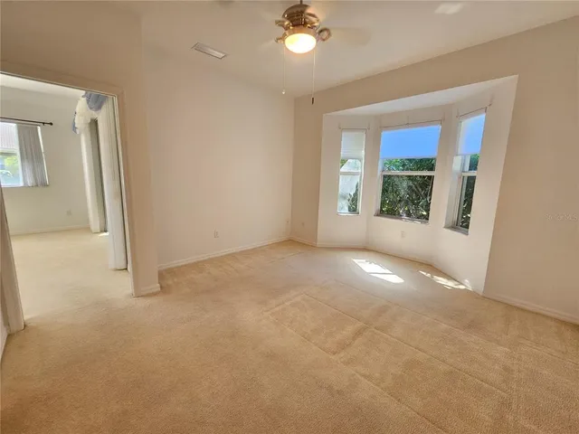 an empty room with windows and entrance