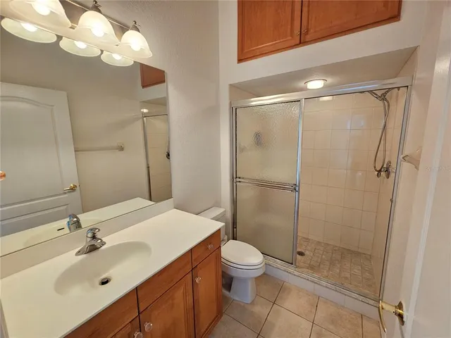 a bathroom with a sink mirror toilet and shower