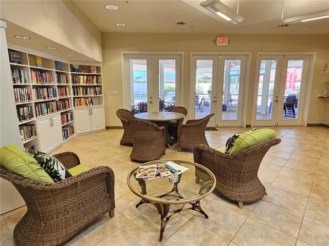 a living room with furniture and a book shelf