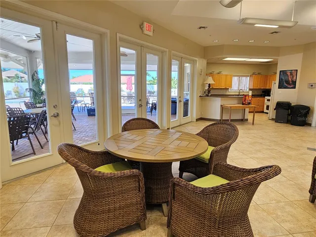 a living room with furniture and large windows