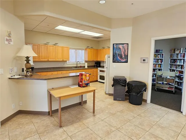 a living room with fireplace furniture and a window