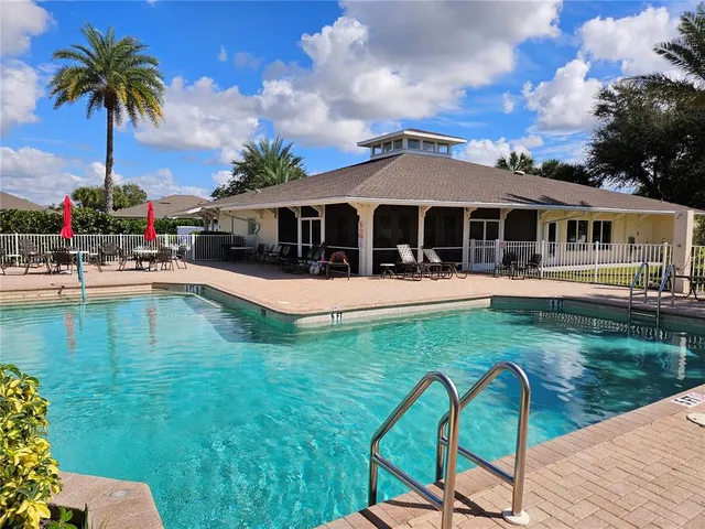 a view of a house with a yard patio and swimming pool