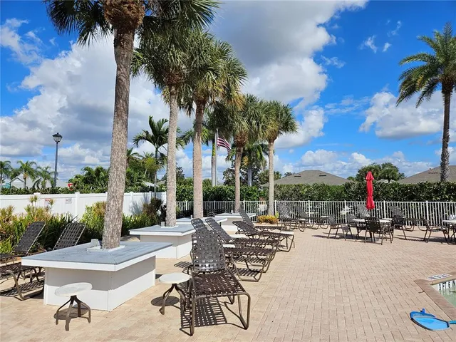 a row of palm trees and swimming pool in the backyard of a house