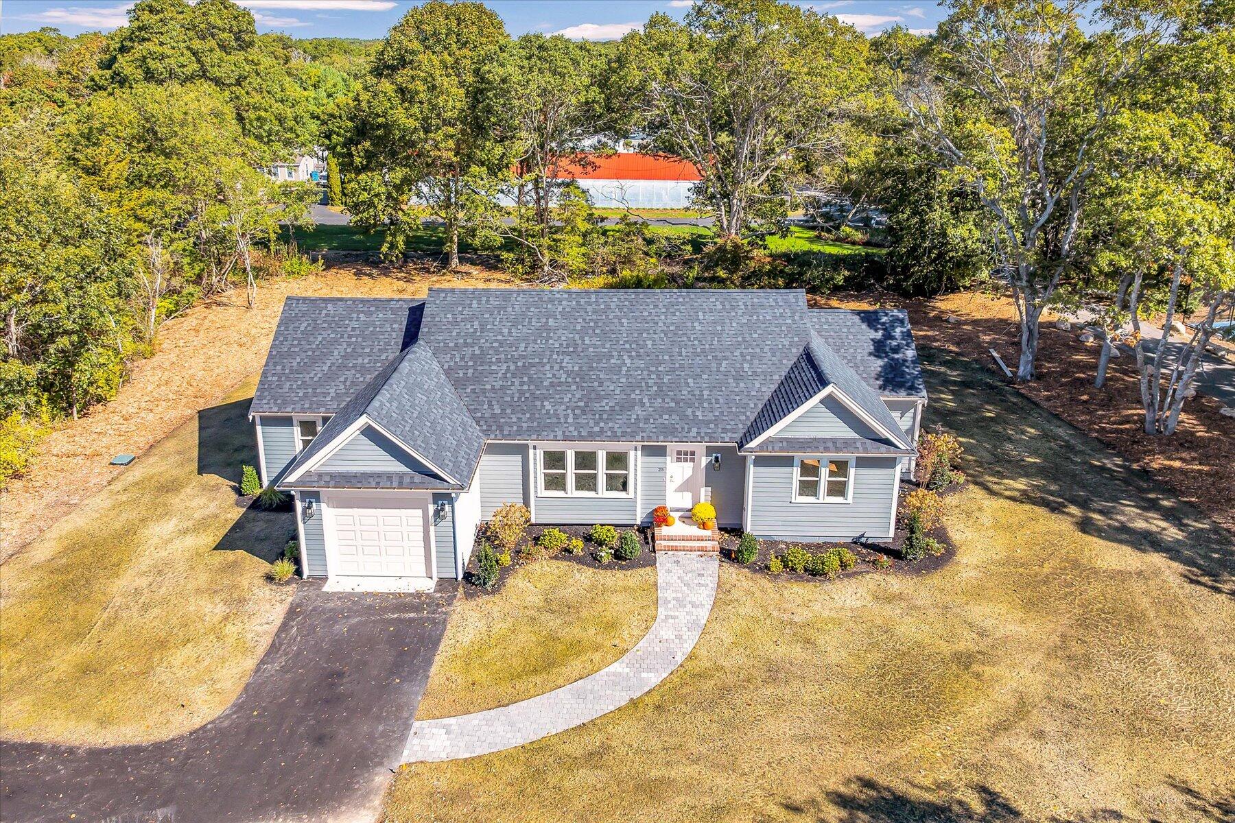 25 Percival Road East Falmouth, MA 02536 - Photo 1 of 31 a house with trees in the background