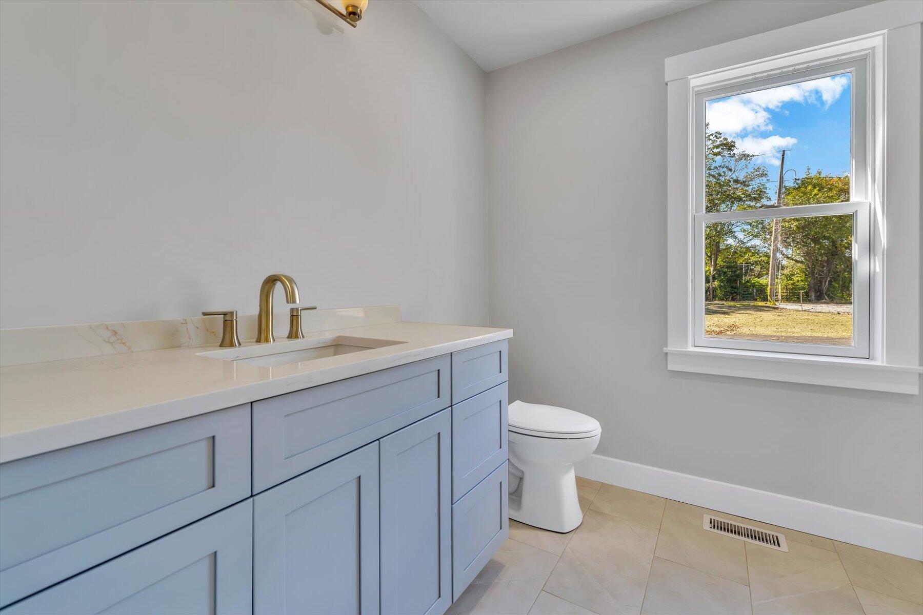 25 Percival Road East Falmouth, MA 02536 - Photo 20 of 31 a bathroom with a sink a toilet and a window