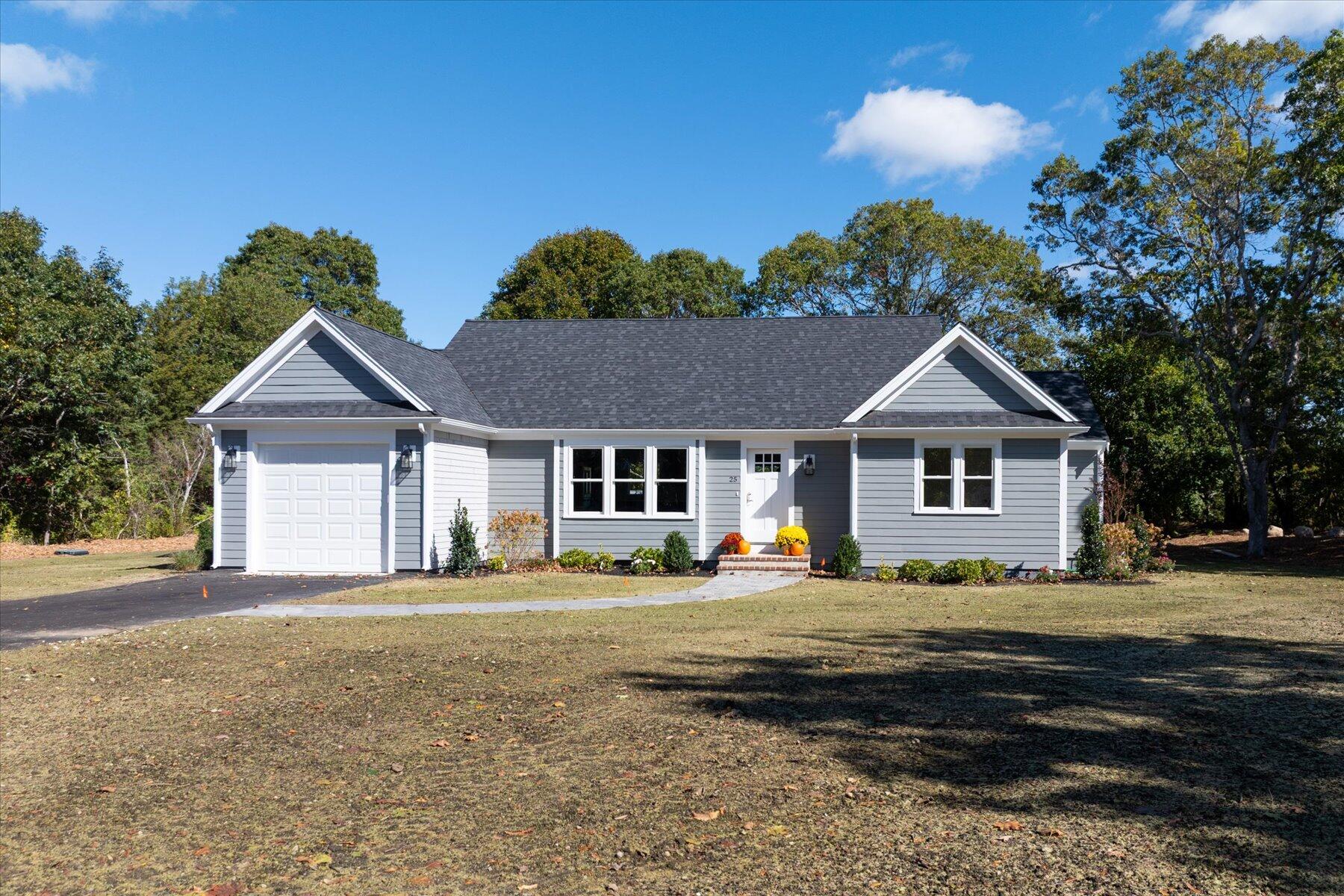 25 Percival Road East Falmouth, MA 02536 - Photo 2 of 31 a front view of a house with a yard