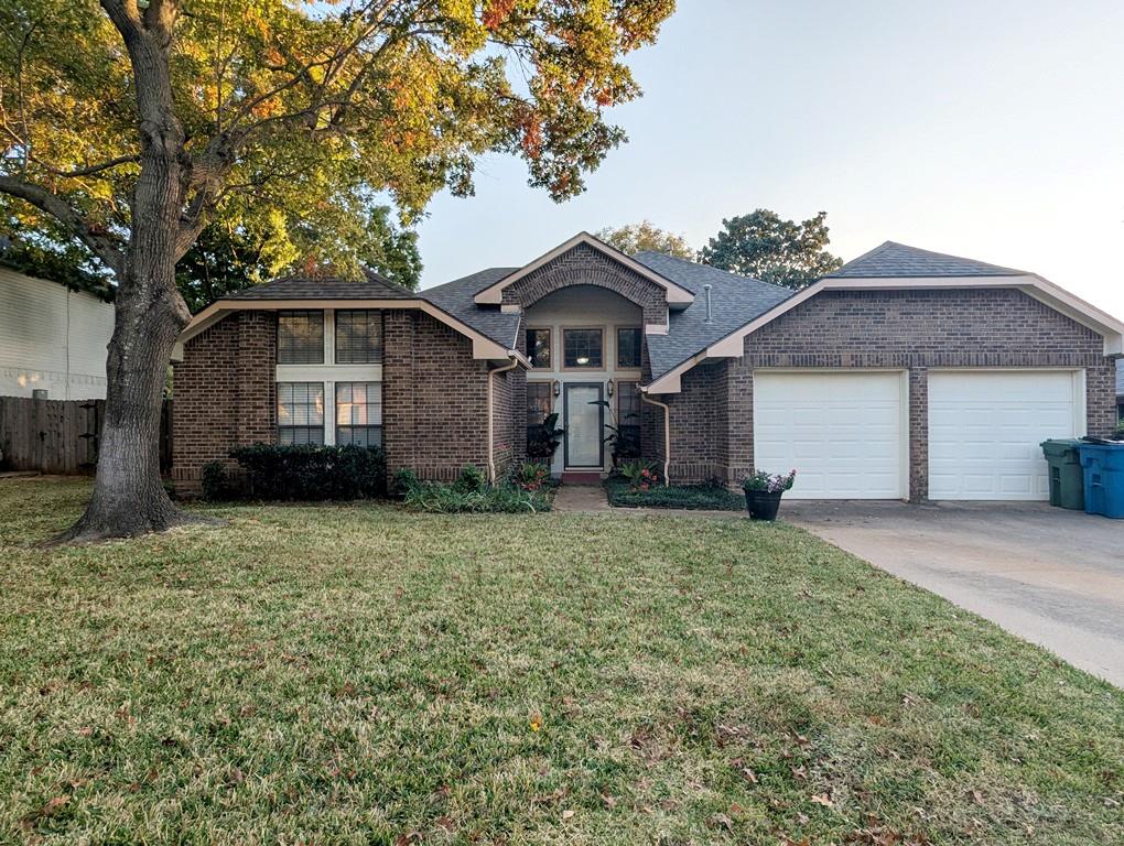 3405 Spring Willow Drive Grapevine, TX 76051 - Photo 2 of 9 a front view of a house with a garden and trees