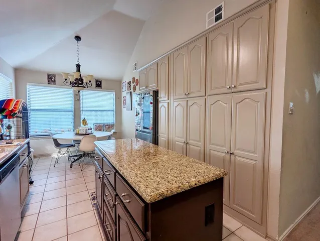 a kitchen with stainless steel appliances granite countertop a stove refrigerator and cabinets