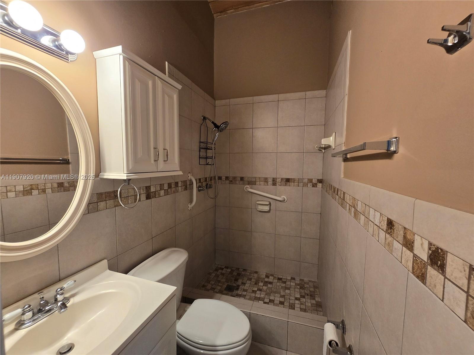 11205 Southwest 114th Ln Circle, Unit 11205 Miami, FL 33176 - Photo 9 of 12 a bathroom with a sink a toilet and shower