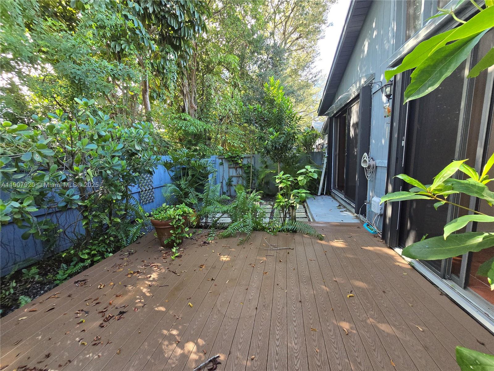 11205 Southwest 114th Ln Circle, Unit 11205 Miami, FL 33176 - Photo 10 of 12 a backyard of a house with lots of green space