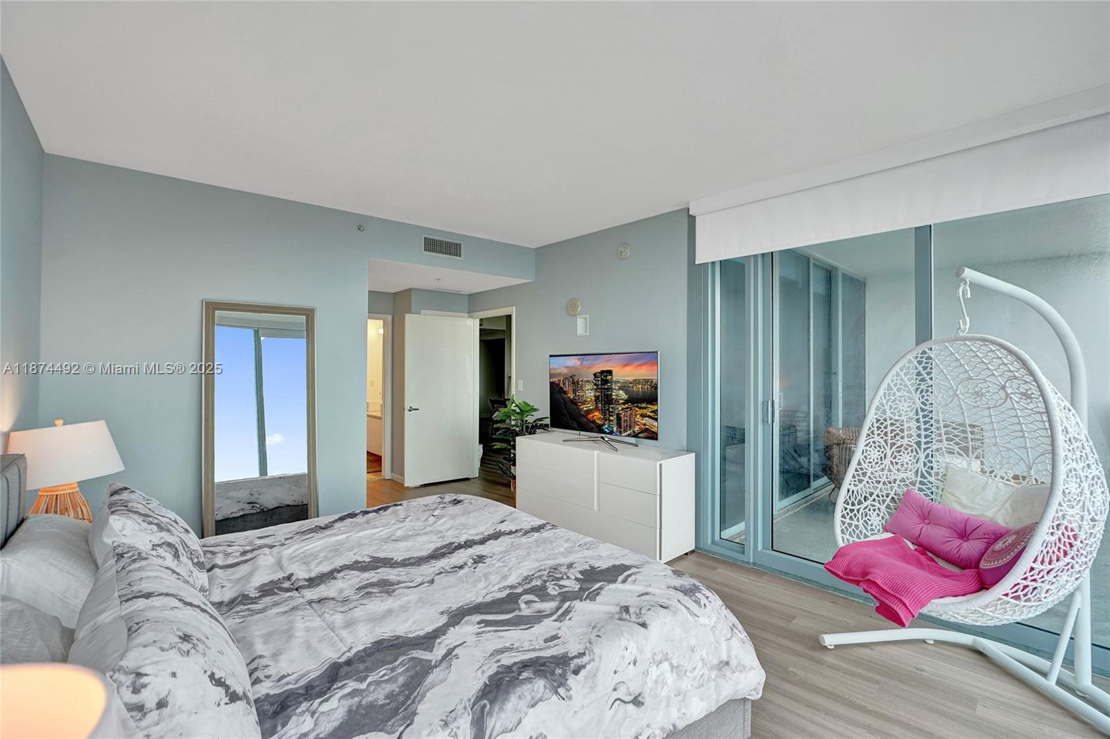 601 Northeast 36th Street, Unit 2703 Miami, FL 33137 - Photo 14 of 64 a bedroom with a bed and wooden floor