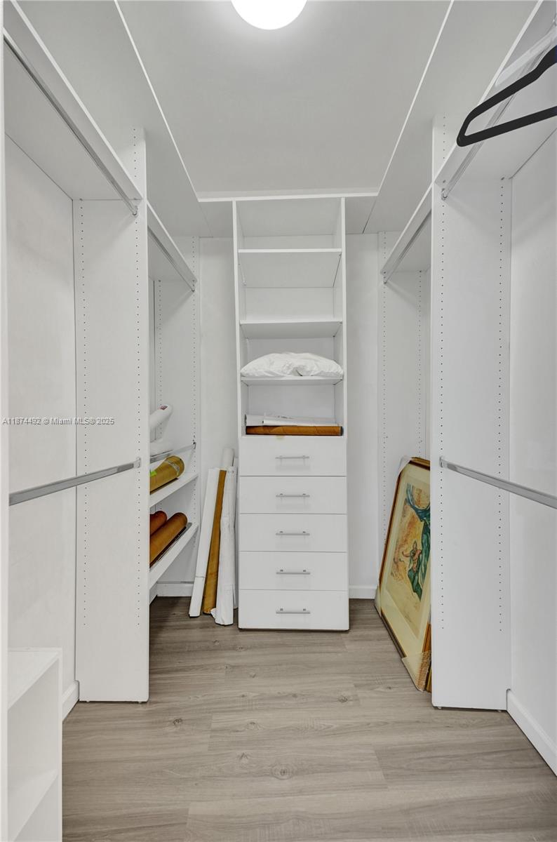 601 Northeast 36th Street, Unit 2703 Miami, FL 33137 - Photo 20 of 64 a view of walk in closet with clothes and shoes