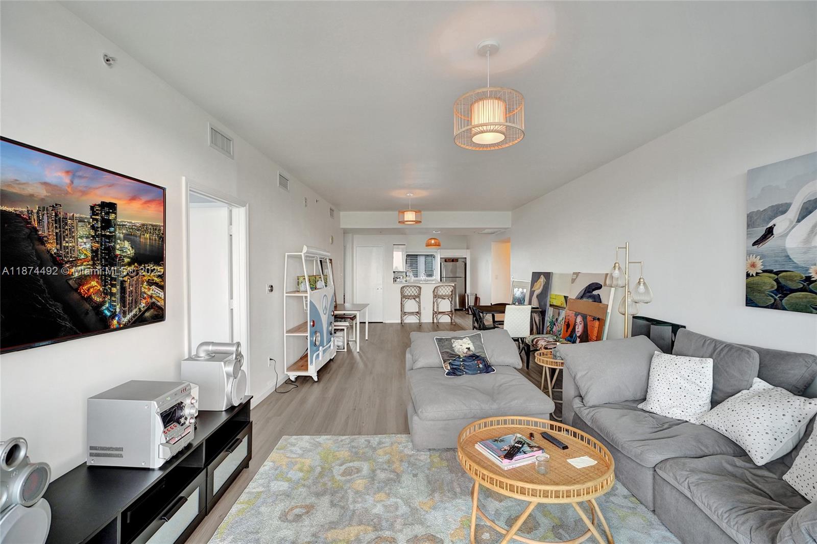 601 Northeast 36th Street, Unit 2703 Miami, FL 33137 - Photo 21 of 64 a living room with furniture and a flat screen tv