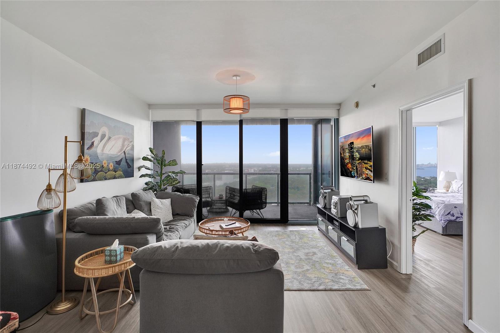 601 Northeast 36th Street, Unit 2703 Miami, FL 33137 - Photo 26 of 64 a living room with furniture and a flat screen tv