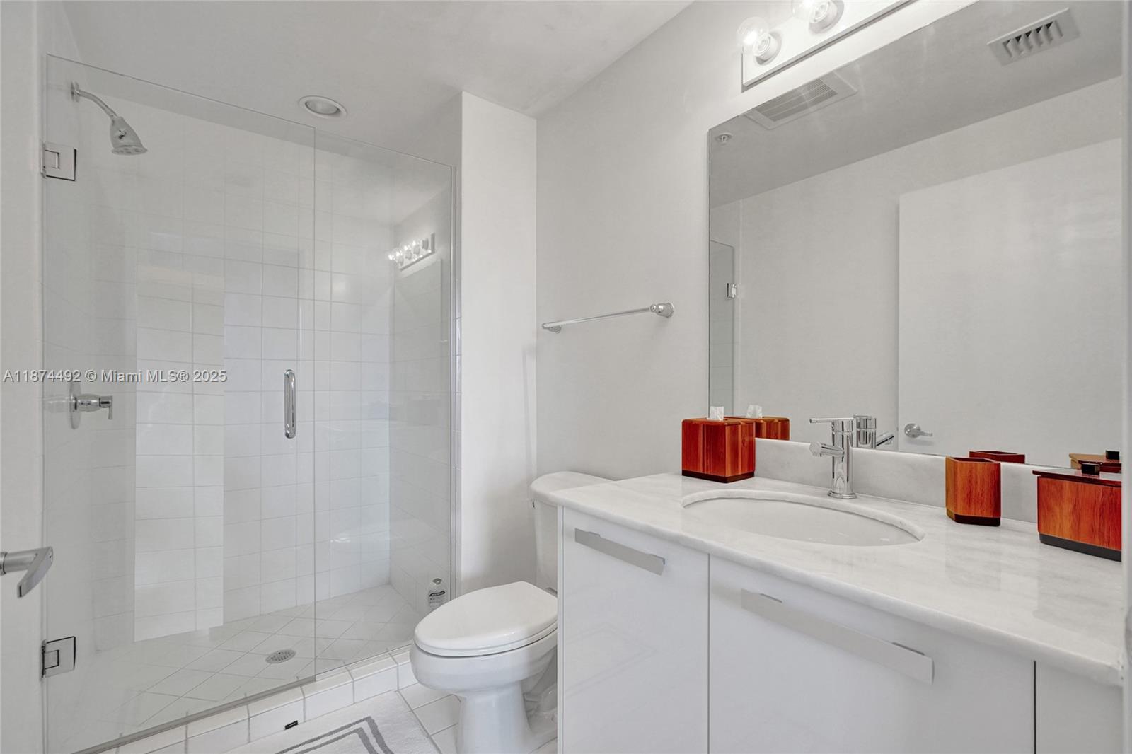 601 Northeast 36th Street, Unit 2703 Miami, FL 33137 - Photo 34 of 64 a bathroom with a sink toilet vanity and shower