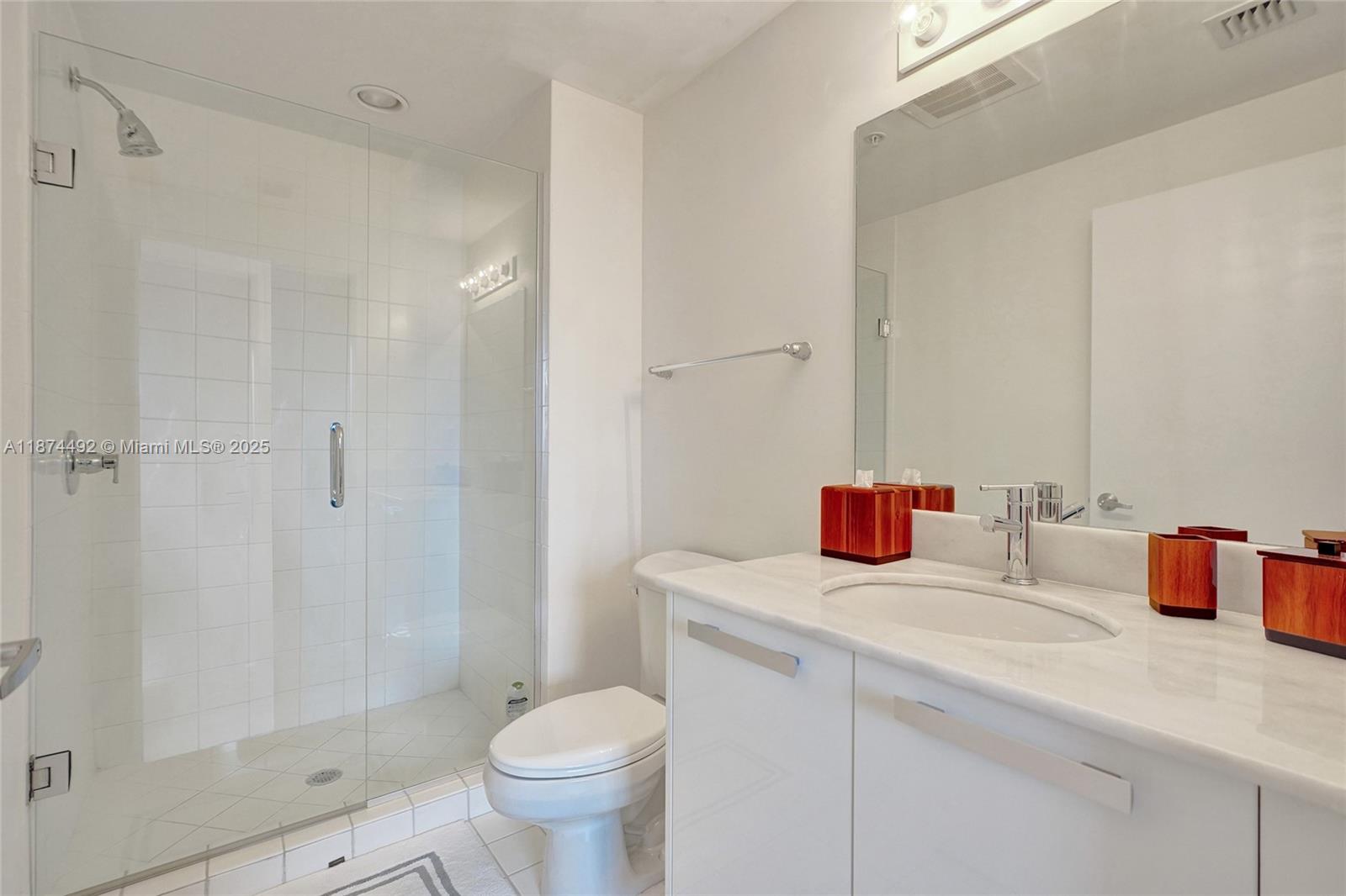 601 Northeast 36th Street, Unit 2703 Miami, FL 33137 - Photo 35 of 64 a bathroom with a sink toilet vanity and shower