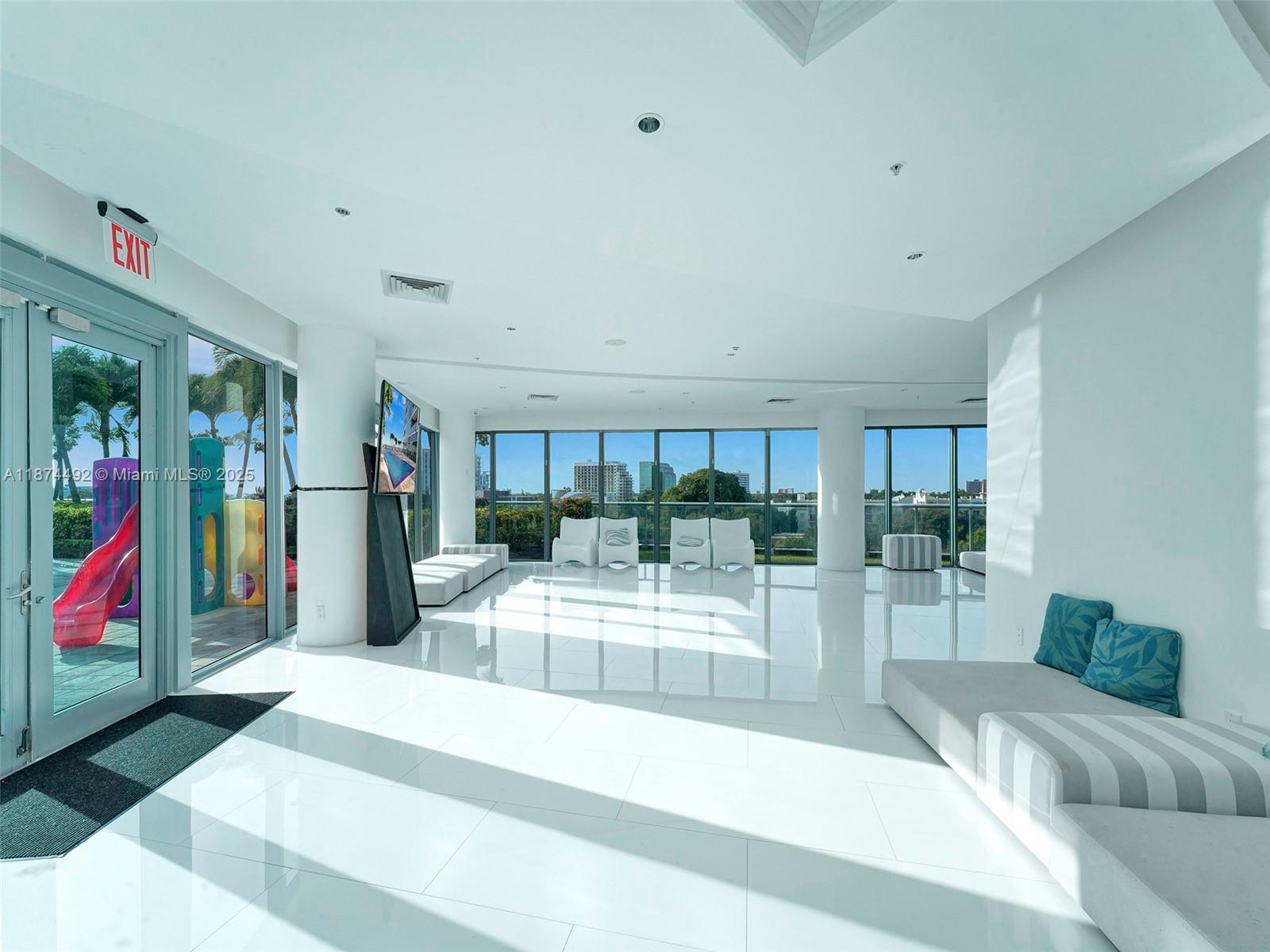 601 Northeast 36th Street, Unit 2703 Miami, FL 33137 - Photo 45 of 64 a living room with furniture and a floor to ceiling window