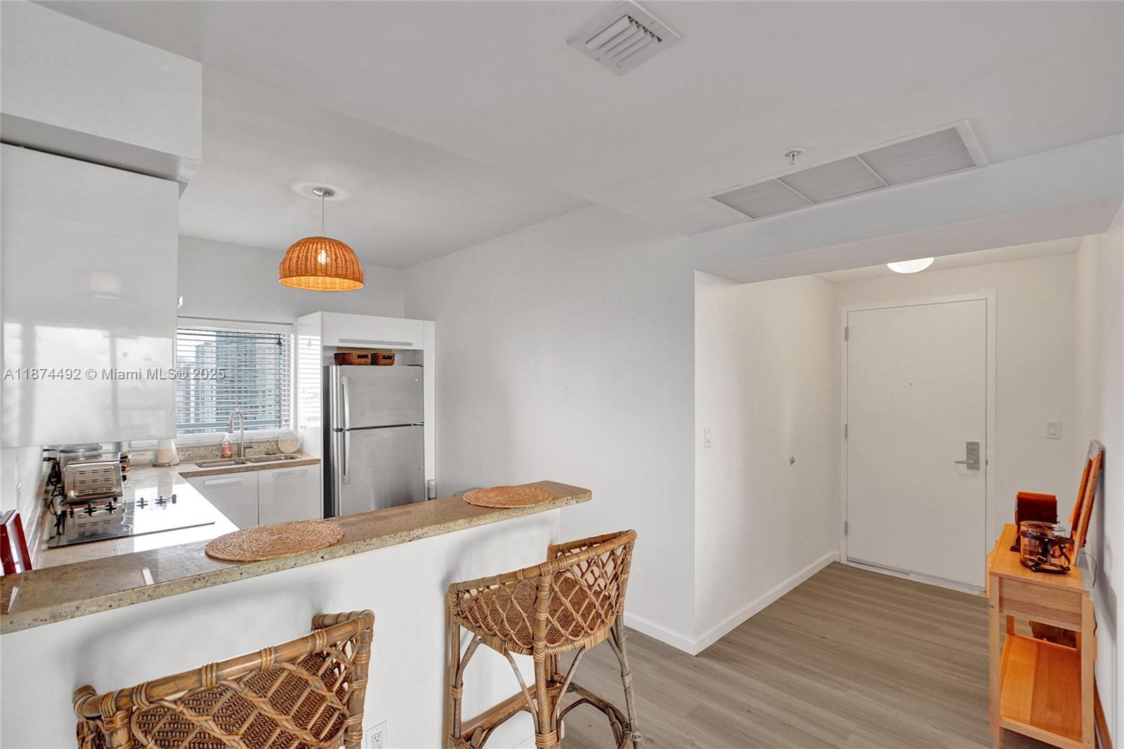 601 Northeast 36th Street, Unit 2703 Miami, FL 33137 - Photo 8 of 64 a kitchen with stainless steel appliances granite countertop a sink and a refrigerator