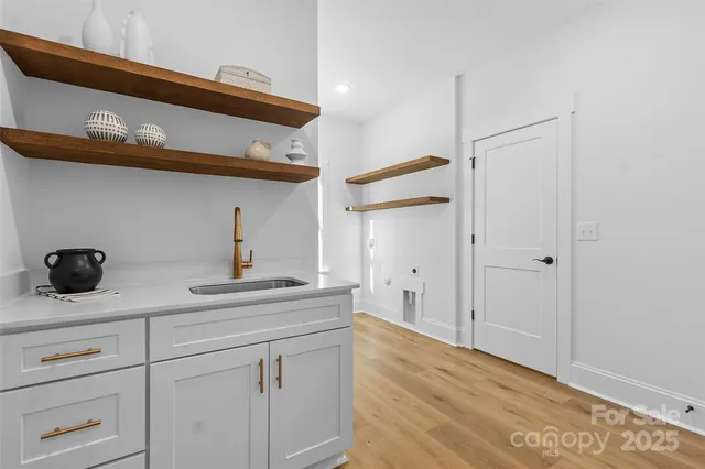 a kitchen with a cabinets and a wooden floor