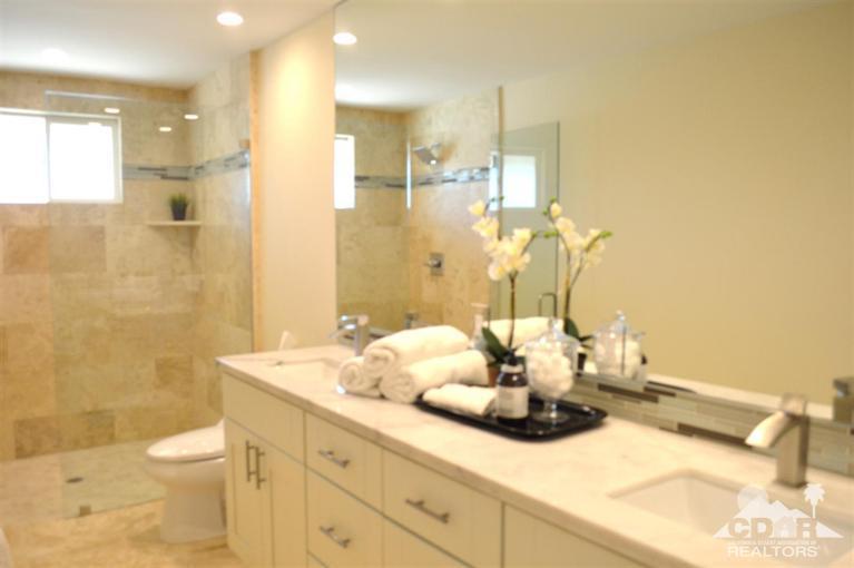 72825 Bel Air Road Palm Desert, CA 92260 - Photo 19 of 23 a bathroom with a granite countertop sink a toilet and a shower