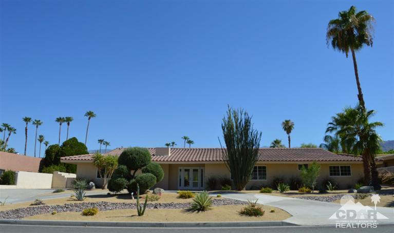 72825 Bel Air Road Palm Desert, CA 92260 - Photo 2 of 23 a front view of a house with garden and plants