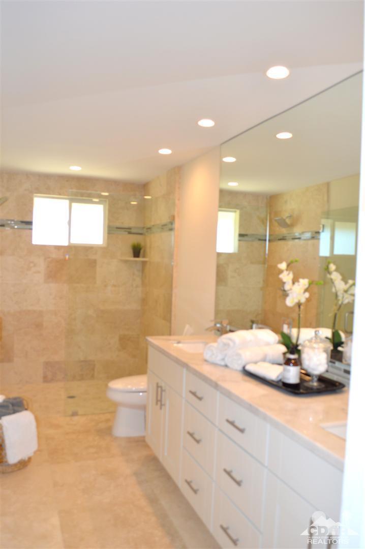 72825 Bel Air Road Palm Desert, CA 92260 - Photo 22 of 23 a bathroom with a granite countertop sink a toilet and shower