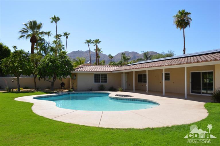 72825 Bel Air Road Palm Desert, CA 92260 - Photo 3 of 23 a front view of a house with a yard and potted plants