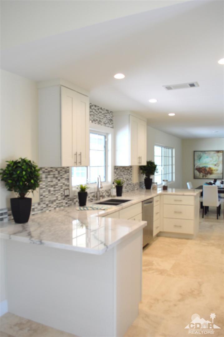 72825 Bel Air Road Palm Desert, CA 92260 - Photo 6 of 23 a kitchen with sink refrigerator and cabinets