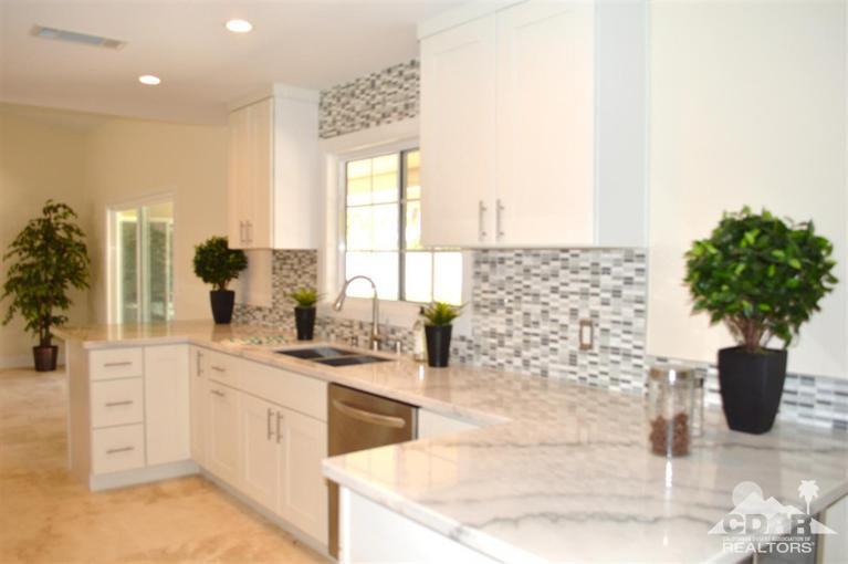 72825 Bel Air Road Palm Desert, CA 92260 - Photo 7 of 23 a kitchen with a sink and a white cabinets