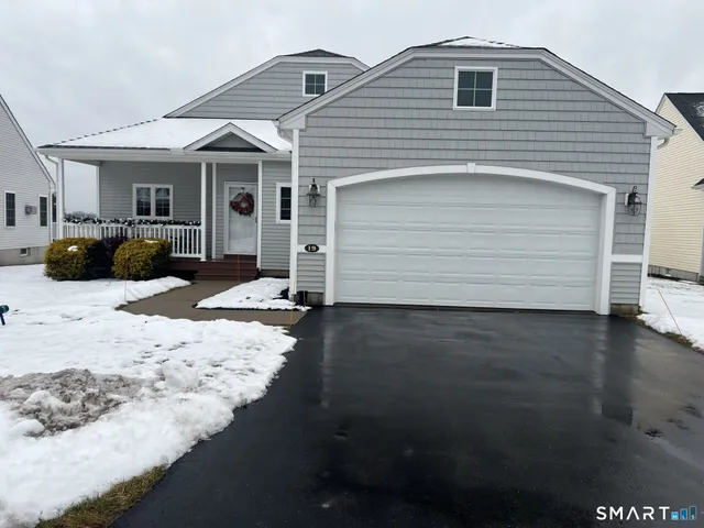 a front view of a house with a yard and seating space