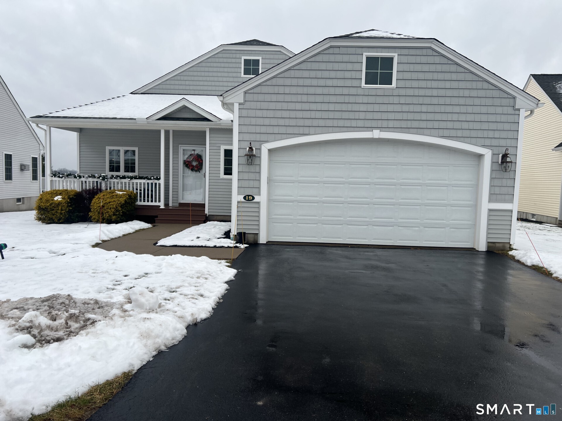 19 Steeple Chase Road, Unit 19 East Windsor, CT 06088 - Photo 1 of 1 a front view of a house with a yard and seating space
