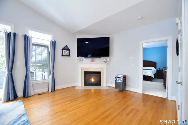 a living room with furniture a fireplace and a flat screen tv