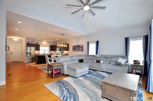 a front view of a house with a yard covered in snow