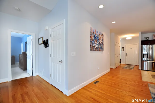 a living room with furniture and a view of kitchen