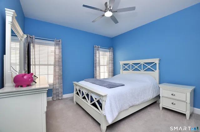a bathroom with double vanity and a mirror