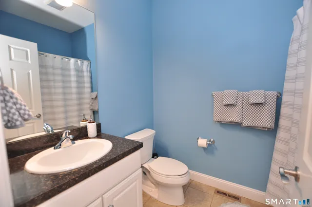 a spacious bedroom with a bed and a flat screen tv