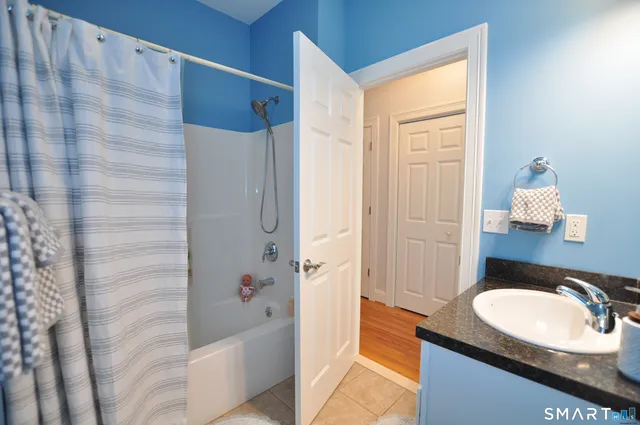 a bedroom with a bed and a painting on the wall