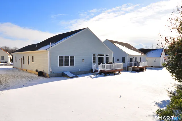 a front view of a house with a yard covered in snow