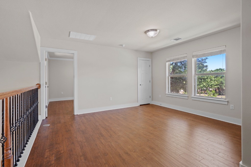 11229 Avery Station Loop, Unit 36 Austin, TX 78717 - Photo 20 of 37 Spare room featuring baseboards and dark wood-type flooring