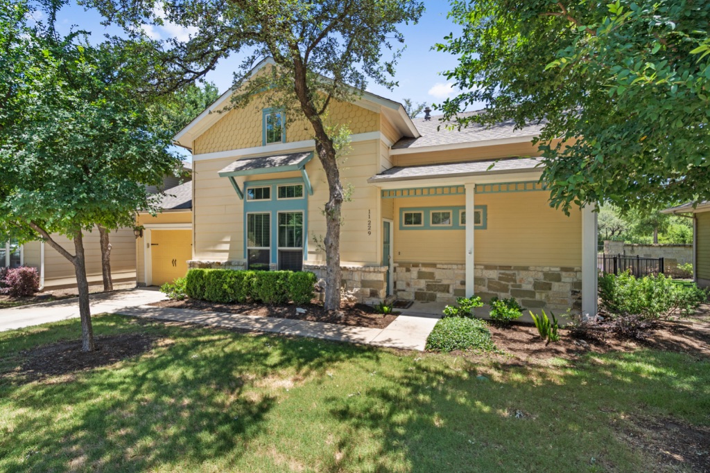 11229 Avery Station Loop, Unit 36 Austin, TX 78717 - Photo 2 of 37 View of front of home with a front lawn, covered porch, and stone siding