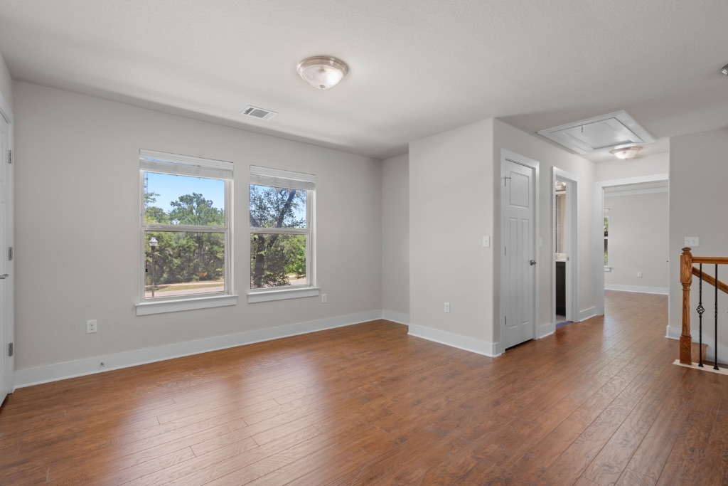 11229 Avery Station Loop, Unit 36 Austin, TX 78717 - Photo 22 of 37 Empty room with dark wood finished floors