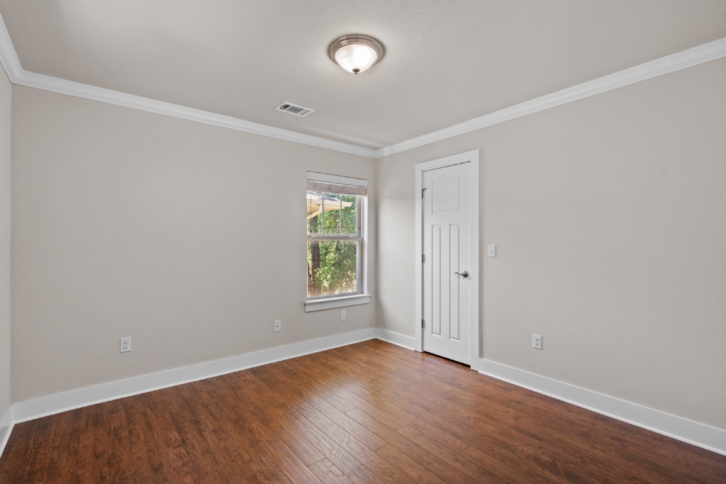 11229 Avery Station Loop, Unit 36 Austin, TX 78717 - Photo 23 of 37 Unfurnished room featuring crown molding and dark wood finished floors