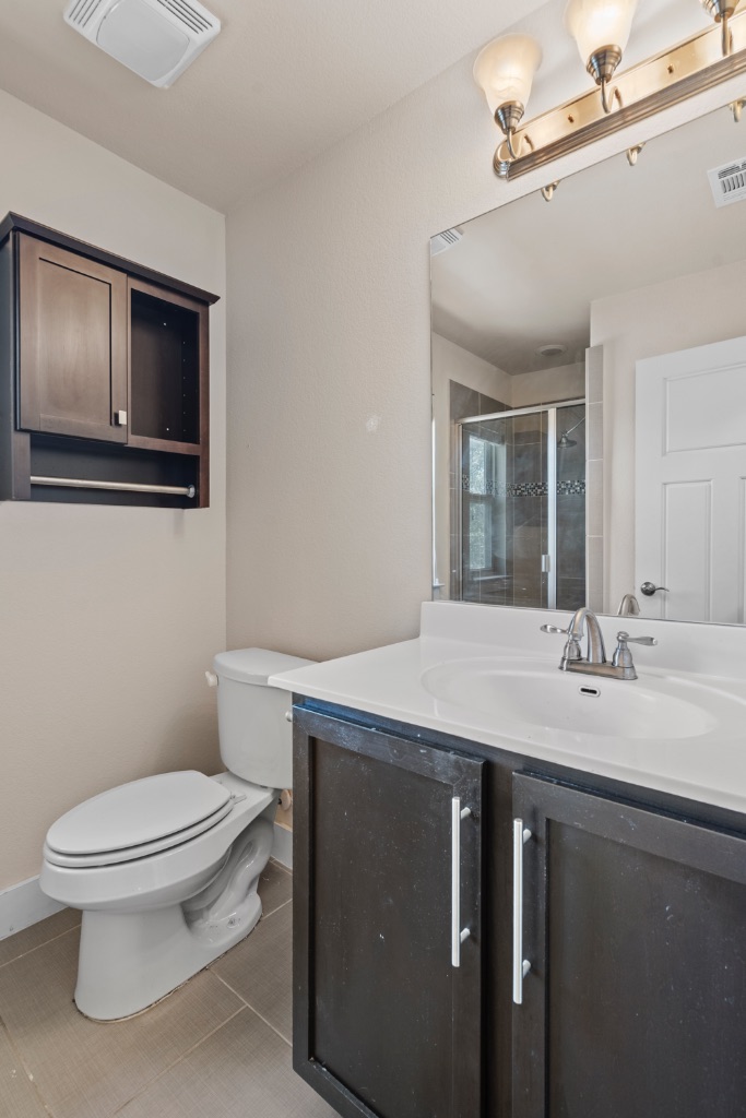 11229 Avery Station Loop, Unit 36 Austin, TX 78717 - Photo 25 of 37 Bathroom featuring a stall shower, vanity, and light tile patterned floors