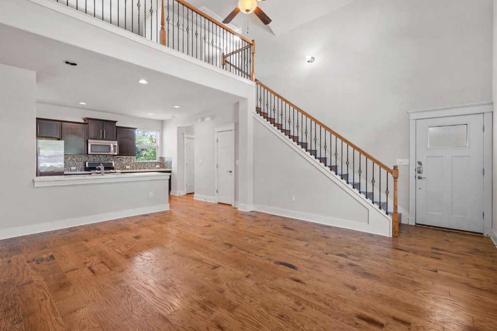 11229 Avery Station Loop, Unit 36 Austin, TX 78717 - Photo 7 of 37 Unfurnished living room featuring light wood-style flooring, a ceiling fan, a high ceiling, and recessed lighting