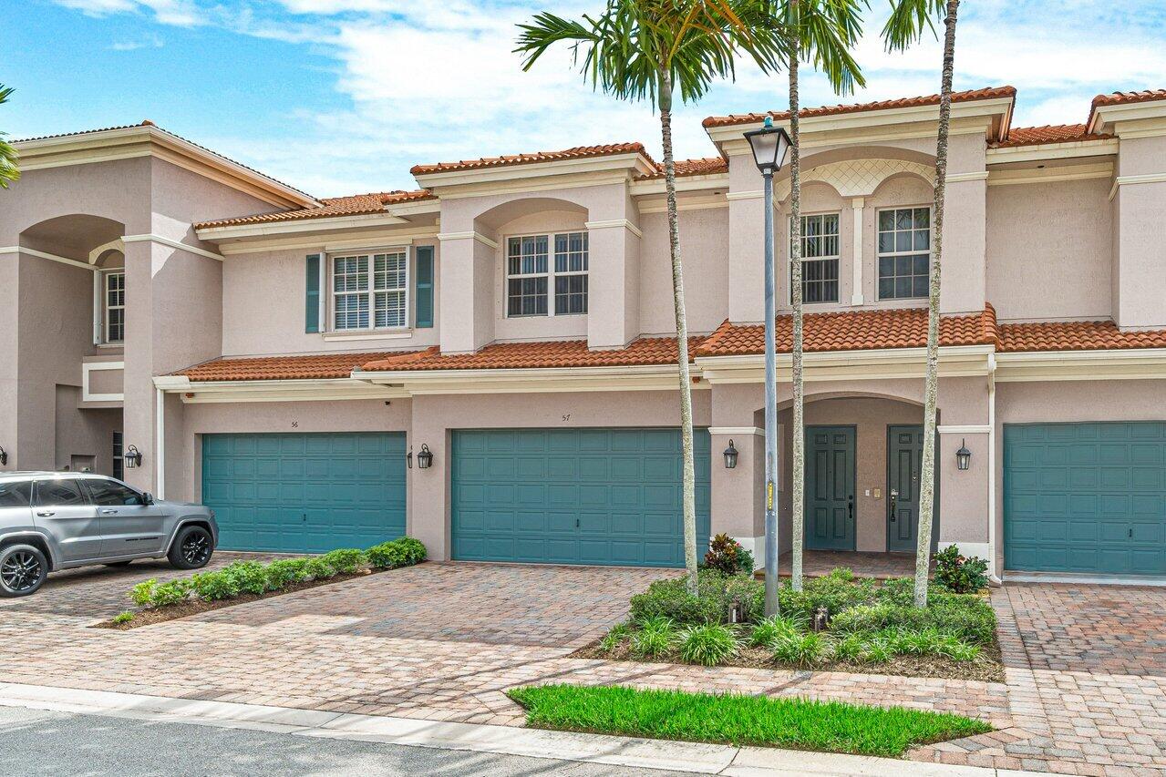 57 Lancaster Road Boynton Beach, FL 33426 - Photo 3 of 32 a front view of a house with a yard and garage