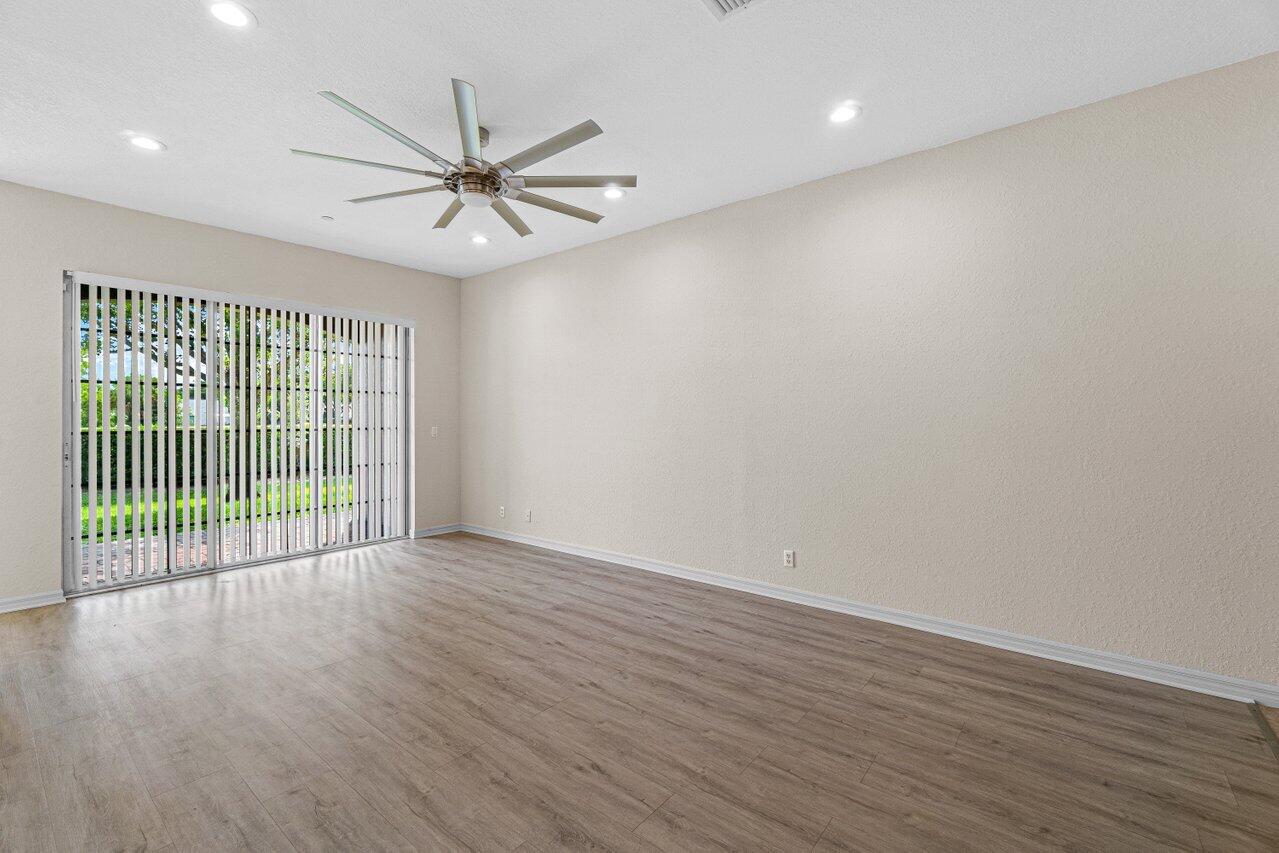57 Lancaster Road Boynton Beach, FL 33426 - Photo 7 of 32 wooden floor in an empty room with a window