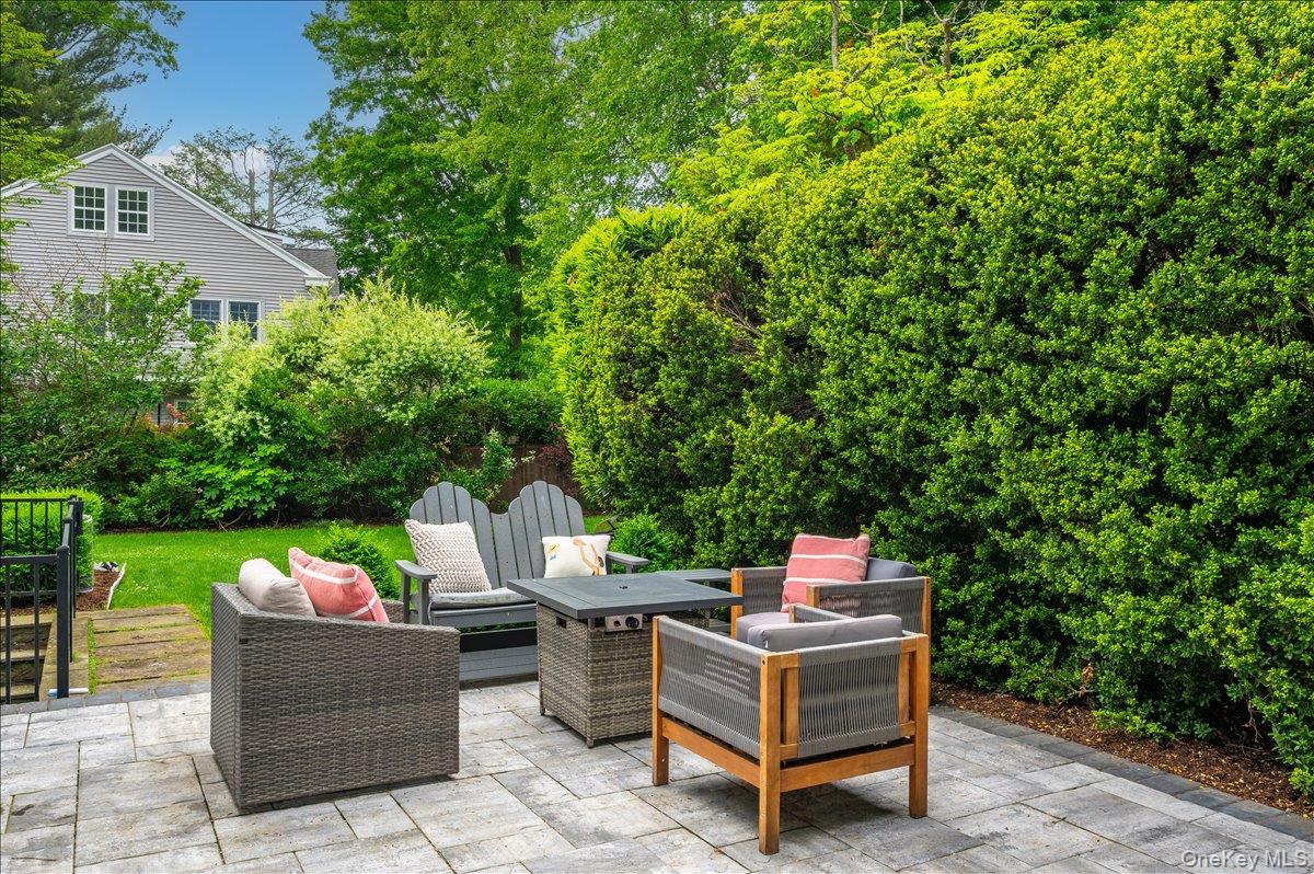 49 Eton Road Larchmont, NY 10538 - Photo 28 of 34 a backyard of a house with a swing table and chairs