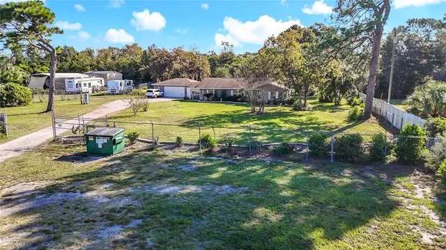a front view of a house with yard and green space