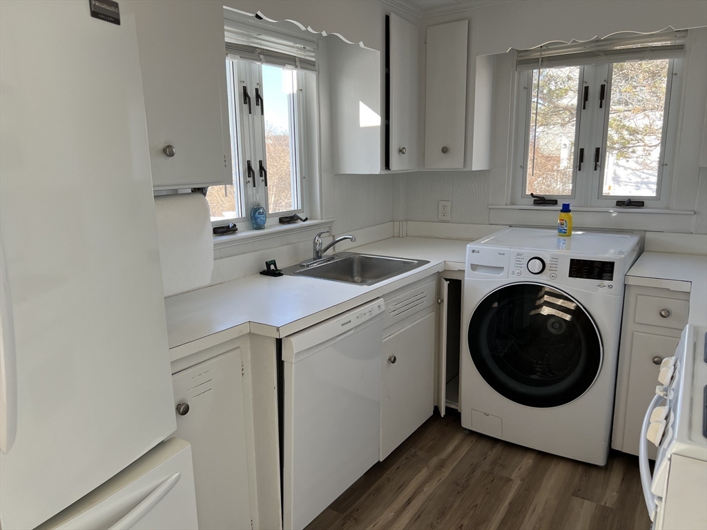 175 Spring Street, Unit 1 Hull, MA 02045 - Photo 5 of 15 a utility room with sink dryer and washer